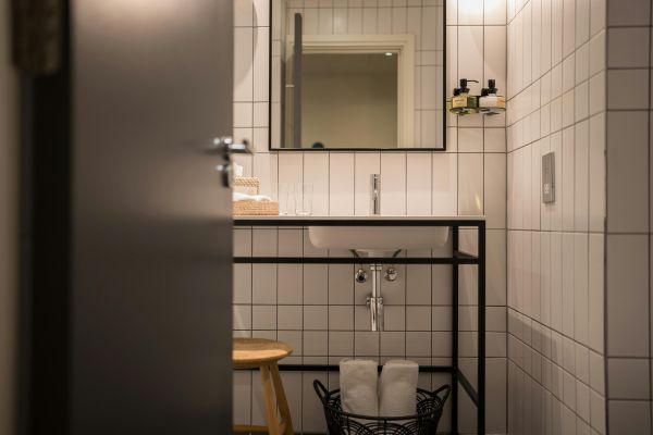 Stylish bathroom with white tiles and modern fixtures in London, UK.